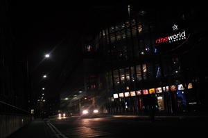 artificial lighting, building, car, car lights, cinema, cinema, city, cityscape, England, eye level view, London, night, pavement, sidewalk, street light, The United Kingdom, winter