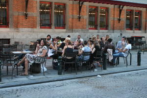 artificial lighting, Belgium, Brussels, cafe, evening, eye level view, group, people, sitting, street, summer, woman