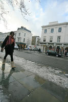 afrocarribean, day, England, London, lowered, natural light, snow, street, The United Kingdom, walking, winter, woman