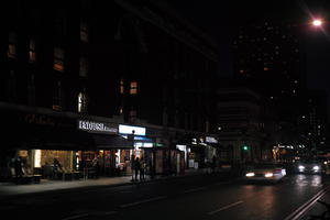 artificial lighting, car, city, city lights, England, eye level view, London, night, outdoor lighting, retail, shopfronts, street, The United Kingdom, urban