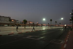 arabic, artificial lighting, autumn, Essaouira, eye level view, man, Morocco, night, palm, street, tree, vegetation, walking