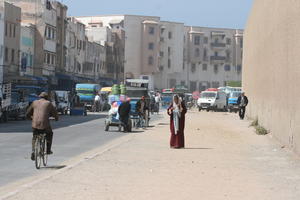 cycling, day, Essaouira, eye level view, man, middleastern, Morocco, street, summer, sunlight, sunny, sunshine, van, walking, woman