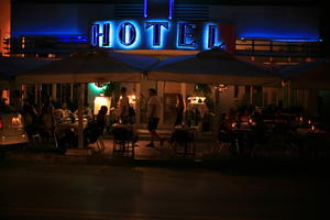 artificial lighting, cafe, chair, eye level view, Florida, fluorescent, furniture, hotel, Miami, night, people, sign, sitting, table, The United States, walking, winter