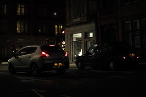 artificial lighting, car, city lights, England, eye level view, London, night, outdoor lighting, retail, shop, street, The United Kingdom