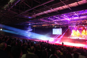 artificial lighting, bright, ceiling, crowd, display, elevated, England, indoor lighting, London, people, screen, stage, The United Kingdom