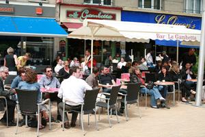 Amiens, bar, cafe, chair, couple, day, eye level view, France, furniture, group, overcast, parasol, people, Picardie, sign, sitting, street, table