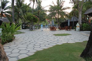 Bali, chair, day, eye level view, furniture, garden, hotel, Indonesia, pavement, plant, resort, summer, sunny, table, tropical