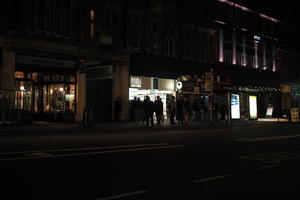 artificial lighting, building, bus stop, England, eye level view, London, night, shop, spring, street, The United Kingdom, urban