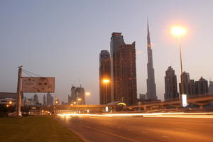 artificial lighting, cityscape, Dubai, Dubayy, dusk, eye level view, flyover, lamppost, outdoor lighting, road, sign, skyscraper, The United Arab Emirates