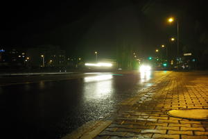 artificial lighting, city lights, eye level view, Kalisz, lowered, night, outdoor lighting, pavement, Poland, street, urban, wet, Wielkopolskie, winter