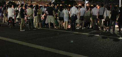 artificial lighting, back, crowd, eye level view, Japan, night, outdoor lighting, people, standing, street, summer