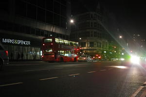 artificial lighting, bus, car, city, city lights, England, eye level view, London, night, outdoor lighting, retail, shopfronts, street, The United Kingdom, urban