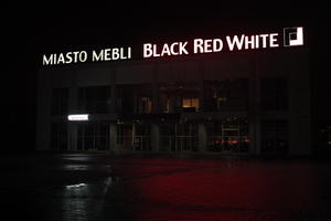 artificial lighting, city, city lights, eye level view, Kalisz, night, outdoor lighting, Poland, reflected, retail, shop, sign, Wielkopolskie