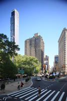 building, couple, crossing, day, elevated, facade, Manhattan, New York, skyscraper, street, summer, sunny, The United States, tree, vegetation, walking, woman