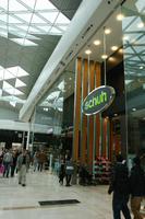 day, England, eye level view, group, indoor lighting, interior, London, mall, natural light, people, retail, shop, shopping, shopping centre, sign, The United Kingdom, walking