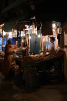 arabic, artificial lighting, autumn, Essaouira, eye level view, food, man, market, Morocco, object, stall