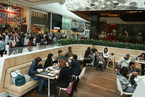 cafe, day, eating, England, eye level view, group, indoor lighting, interior, London, mall, natural light, people, shopping centre, sitting, The United Kingdom