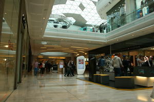 day, England, eye level view, group, indoor lighting, interior, London, mall, natural light, people, retail, shop, shopping, shopping centre, The United Kingdom, walking