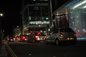 artificial lighting, car, city lights, England, eye level view, London, night, outdoor lighting, street, The United Kingdom, traffic