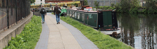 back, boat, canal, casual, day, England, eye level view, London, male, man, path, pavement, spring, sunny, The United Kingdom, walking