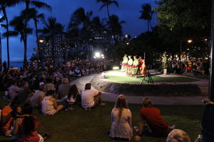 artificial lighting, crowd, dancing, evening, eye level view, Hawaii, outdoor lighting, people, performer, sitting, stage, summer, The United States