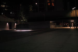 artificial lighting, city, city lights, England, eye level view, London, lowered, night, outdoor lighting, pavement, The United Kingdom, urban