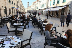 autumn, bright, cafe, canopy, chair, Croatia, day, Dubrovacko-Neretvanska, Dubrovnik, eye level view, furniture, group, man, natural light, people, sitting, street, sunny, table