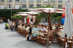 Amiens, cafe, chair, day, eye level view, France, furniture, group, overcast, parasol, people, Picardie, sitting, street, table