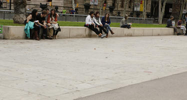 autumn, Barcelona, casual, Cataluña, day, diffuse, diffused light, eye level view, group, pavement, people, sitting, Spain, street