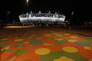 artificial lighting, England, eye level view, London, night, outdoor lighting, pavement, square, stadium, summer, The United Kingdom