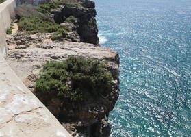 day, elevated, eye level view, Faro, Faro, flower, greenery, looking down, open space, Portugal, rock, rockery, rocks, seascape, shrub, summer, sunlight, sunny, vegetation, waterfront