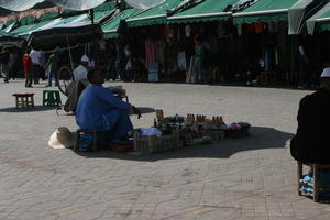 autumn, day, eye level view, man, market, Marrakech, Marrakesh, middleastern, Morocco, square, stall, sunny