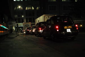 artificial lighting, cab, car, England, eye level view, London, night, spring, street, The United Kingdom, urban, walkway