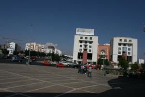 Agadir, arabic, autumn, car, day, eye level view, group, man, Morocco, plaza, street, sunlight, sunny, sunshine