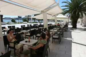 cafe, canopy, chair, Croatia, day, eye level view, furniture, group, people, sitting, Split, Splitsko-Dalmatinska, summer, sunlight, sunny, talking, texting