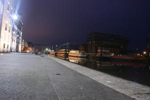 artificial lighting, boat, city, city lights, England, eye level view, Gloucester, harbour, lowered, night, outdoor lighting, promenade, ship, The United Kingdom, urban