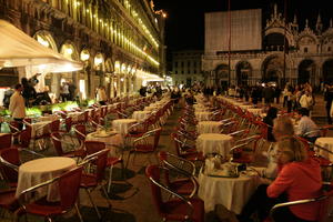 artificial lighting, cafe, chair, couple, crowd, eye level view, furniture, Italia , night, outdoor lighting, people, restaurant, sitting, standing, table, Veneto, Venice, waiter