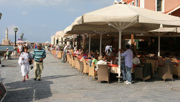 autumn, cafe, casual, Chania, couple, day, eye level view, furniture, Greece, group, Iraklion (Crete), people, sitting, sunny, umbrella, walking