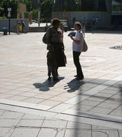 backlight, bright, day, England, eye level view, group, London, multiracial, people, side, spring, square, standing, sunny, The United Kingdom