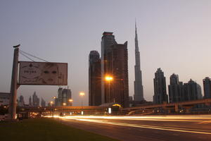 artificial lighting, cityscape, Dubai, Dubayy, dusk, eye level view, flyover, lamppost, outdoor lighting, road, sign, skyscraper, The United Arab Emirates