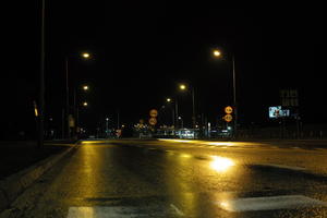 artificial lighting, city lights, eye level view, Kalisz, lowered, night, outdoor lighting, Poland, street, urban, wet, Wielkopolskie, winter