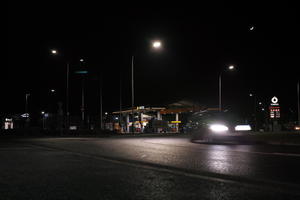 artificial lighting, city lights, eye level view, Kalisz, night, outdoor lighting, petrol station, Poland, street, urban, wet, Wielkopolskie, winter