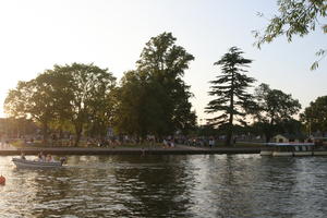 boat, broad-leaf tree, broad-leaved tree, canal, coniferous, day, deciduous, dusk, England, eye level view, group, outdoors, people, picnicking, sailing, sitting, Stratford-Upon-Avon, summer, sunny, The United Kingdom, tree, treeline