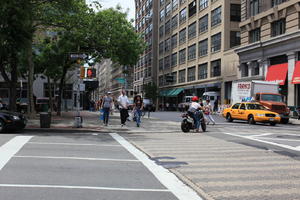 car, day, eye level view, group, man, Manhattan, motorcycling, New York, people, sign, street, sunny, taxi, The United States, traffic light