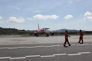 airplane, airport, autumn, cloudy, day, eye level view, Malaysia, Malaysia, man, natural light, people, runway, walking