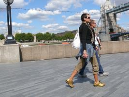 couple, day, England, eye level view, group, London, pavement, people, summer, sunny, The United Kingdom