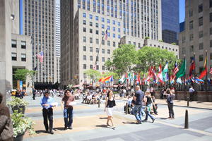 asian, building, crowd, day, eye level view, facade, flag, man, Manhattan, New York, people, sitting, skyscraper, standing, street, summer, sunny, The United States, walking, woman