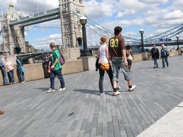 couple, day, England, eye level view, group, London, man, pavement, people, sunny, The United Kingdom