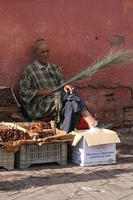 arabic, crate, day, eye level view, food, man, Marrakech, Marrakesh, Morocco, natural light, object, sitting, stall, street, sunny