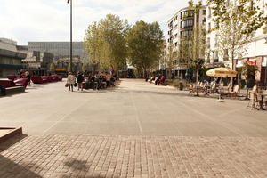 cafe, casual, day, eye level view, France, furniture, group, Ile-De-France, Paris, pavement, people, spring, square, sunny, umbrella